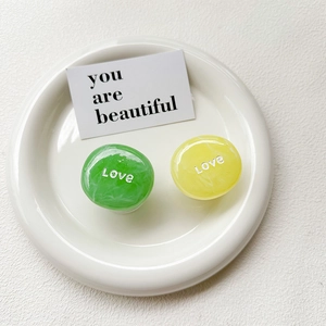 Detail of marble textured expandable phone sockets in lime and yellow with Love text