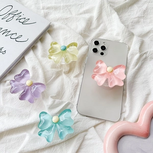 Detail of candy-colored resin bow phone grips in purple, yellow, pink and cyan