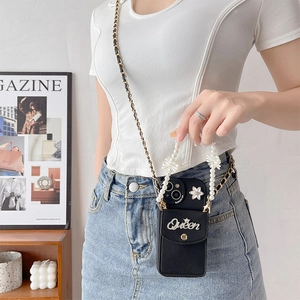 Detail of luxury black leather phone case with Queen crown decor and pearl handle strap