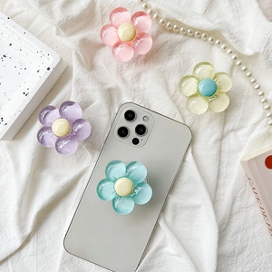 Detail of floral pop socket grip in pastel colors on a stylish phone back view