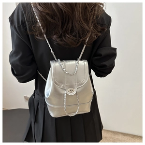Detailed view of silver mini backpack with metallic PU texture and chain strap
