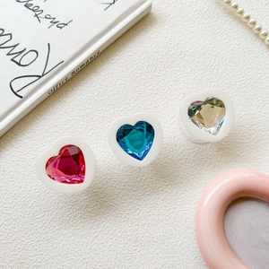 Detailed close-up of heart-shaped crystal phone sockets in red, blue, and champagne