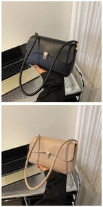 Detail view of stylish square bags with golden metal locks in beige and black colors