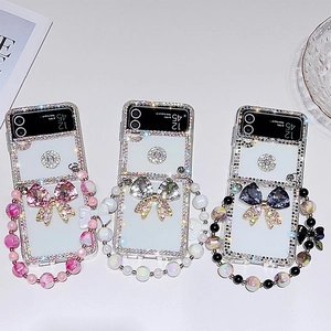 Coque luxe pour Samsung Z Flip 6 avec strass, nœud papillon et chaîne en perles