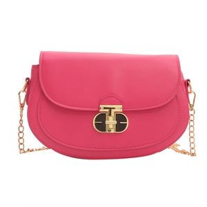 Chic rose pink saddle crossbody bag with luxury gold T-lock and chain strap on white background