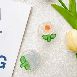 Detail of floral phone socket with blue outlines, orange cores and bead texture