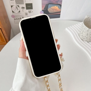 Detail of white iPhone case featuring a luxury pearl and gold-tone chain hand strap