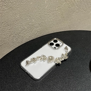 Close-up of luxury iPhone case with rhinestone heart chain and silver metal frame