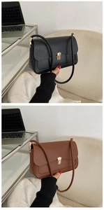 Detail of elegant leather crossbody bags with gold hardware buckles in black and brown