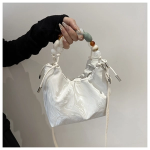 Close-up of marble pattern drawstring bucket bag with colorful beaded handle