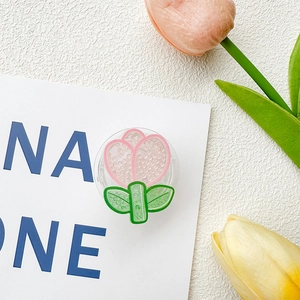 Detail view of pink tulip phone grip with textured petals on white background