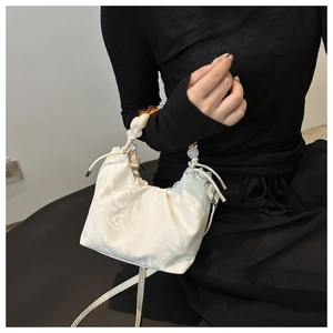 Detail of white marble texture cloud bag with beaded handle and drawstring closure