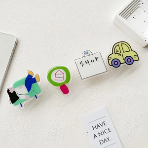 Detailed view of four acrylic cartoon lifestyle charms including sofa, house, and shopping bag