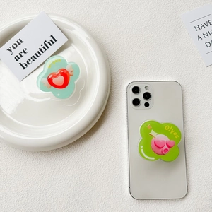 Detail of collapsible heart-shaped phone socket grip with cute wing design and text