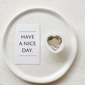 Detailed close-up of a transparent heart-shaped crystal phone socket on a white base