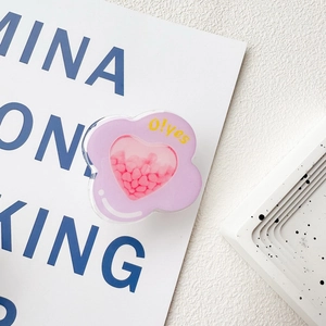 Close-up of purple flower phone socket with pink heart shaker and O!yes text detail