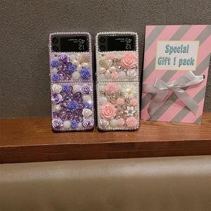 Detail of luxury Samsung Z Flip6 case with handmade pearls, 3D resin roses and crystals