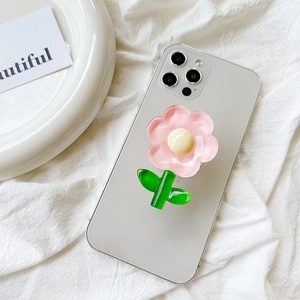 Detail of pink tulip flower phone pop socket mount on a silver smartphone back