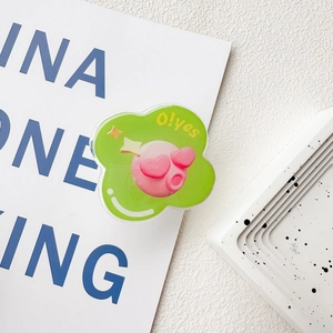 Detail of cute green acrylic cloud phone grip with a pink cartoon character and heart eyes