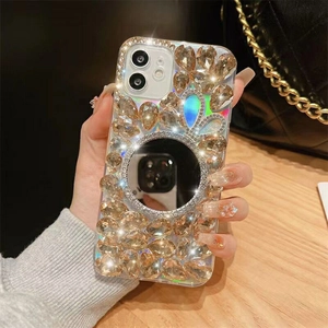 Detail of luxury iPhone case with champagne rhinestones and a round vanity mirror