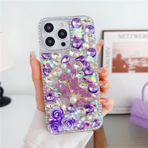 Detail of luxury iPhone case with purple roses, pearls, and crystals in a hand-held view
