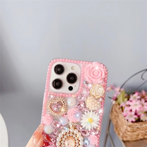 Detailed view of iPhone case with pink resin roses, white daisies, and pearl rhinestones