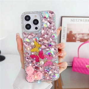 Detail of luxury iPhone case featuring pink 3D roses, glittery crystals, and diamond butterfly