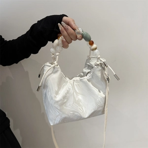 White marble pattern bucket bag with colorful beaded handle and crossbody strap
