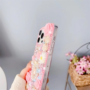 Close-up of pink 3D roses, pearls and rhinestones on a decorative iPhone case side view
