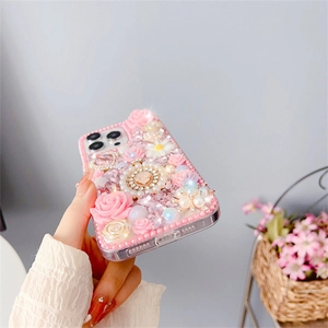 Detail of luxury iPhone case featuring 3D pink roses, pearls, and sparkling rhinestones