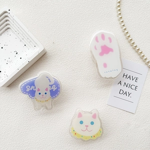 Three cute acrylic cat phone sockets with paw and cat patterns on white textured background