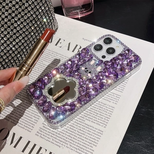 Detail of luxury purple rhinestone iPhone case with crystal bunny and circular makeup mirror
