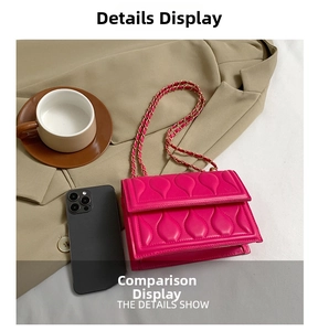 Detail view of fuchsia quilted crossbody bag with gold chain strap and stylish accessories
