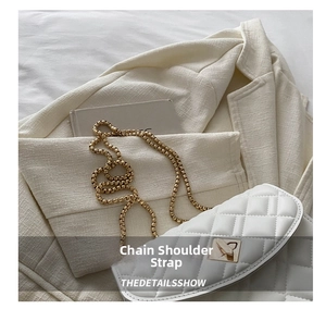 Detail of white quilted chain bag with gold metal lock and beaded shoulder strap