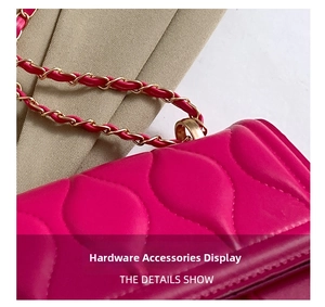 Detailed close-up of wavy quilted pattern and golden metal chain on rose red crossbody bag