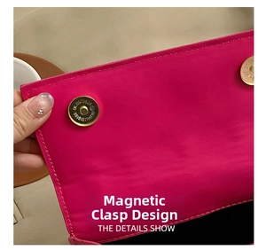 Detail of hot pink handbag featuring secure double metal magnetic buckle closure