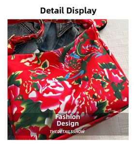 Macro shot of red floral canvas crossbody bag with traditional peony and phoenix embroidery