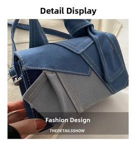 Close-up of contrast denim stitching and silver metal buckle on the canvas crossbody bag