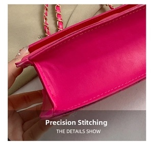 Macro shot of rose pink leather handbag featuring gold chain strap and precision stitching