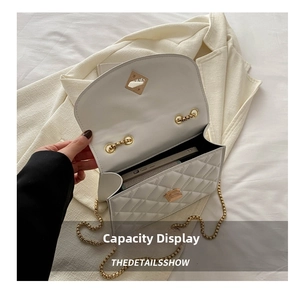 Internal view of white quilted chain bag showing capacity for a smartphone