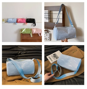 Detail of multi-color cylindrical crossbody bags with textured fabric and wide straps