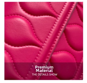 Detail of rose red quilted faux leather with wavy leaf stitching on a square bag
