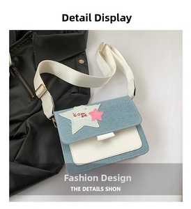 Detail of denim and faux leather patchwork bag with star patch and wide canvas strap
