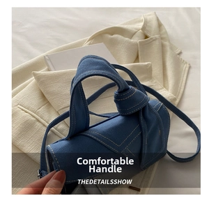 Detail of the knotted handle and denim texture on the blue crossbody bag for women