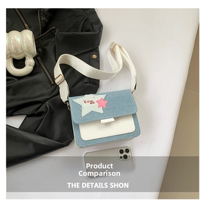 Detail of denim crossbody bag with star patchwork and wide shoulder strap
