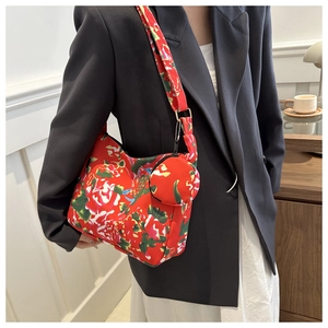 Chic floral shoulder bag with matching coin purse shown on a fashion model in a studio