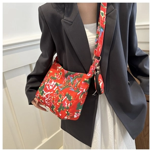 Detail of red floral nylon hobo bag with matching mini round pouch and wide strap