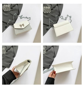 Dettaglio borsa a tracolla color crema con glitter argento e chiusura a fiocco