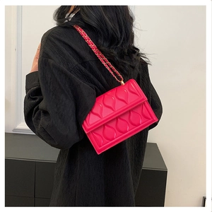 Pink quilted crossbody bag with textured waterdrop pattern and gold chain strap