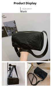 Detail showing the black cylinder bag with pleated texture and adjustable wide strap